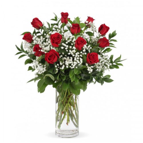 Elegant red rose bouquet with white baby's breath flowers and green foliage arranged in a glass vase for romantic gifts and special occasions